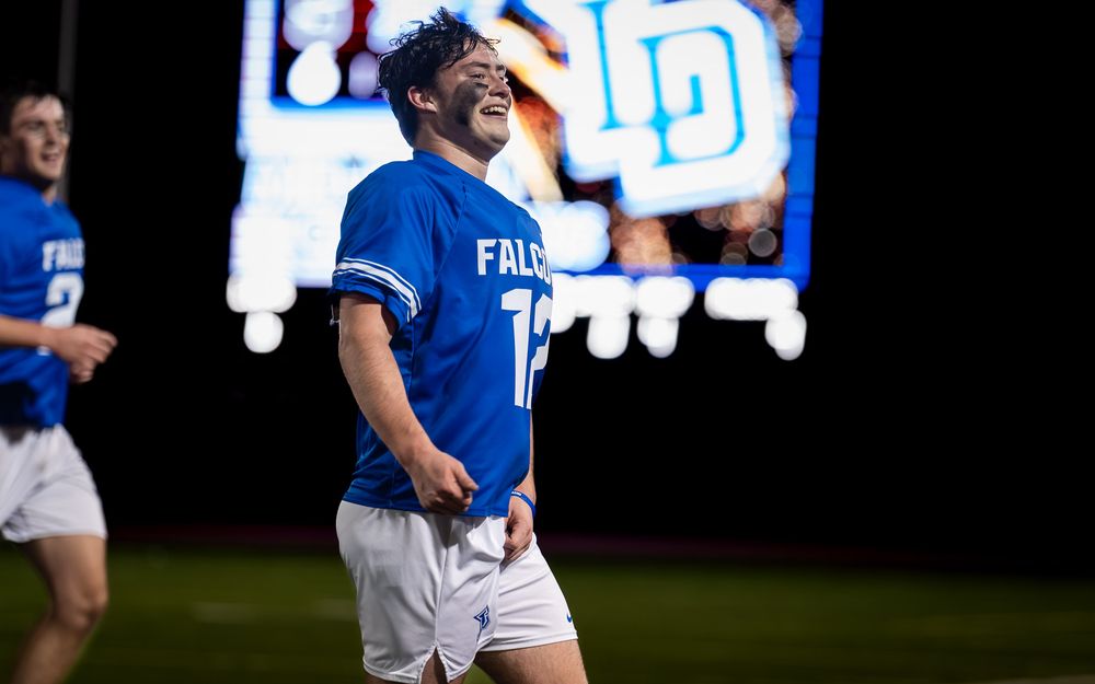 Lower Dauphin lacrosse player celebrating in front of the LD scoreboard at the 2026 Mid Penn title by SportsFox Photography, Hershey PA.