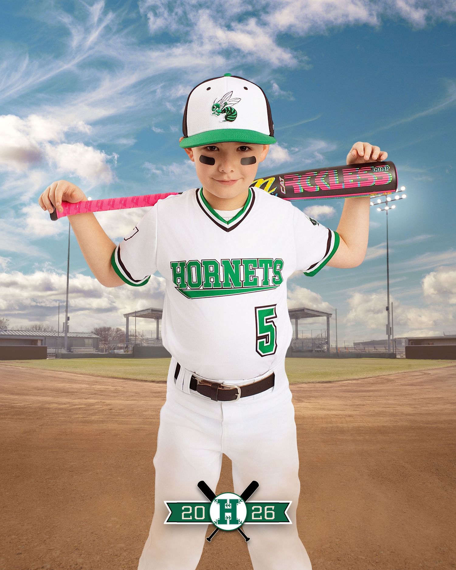 Young baseball player in Hornets #5 uniform poses with pink bat on shoulders at baseball field, 2026 team photo.