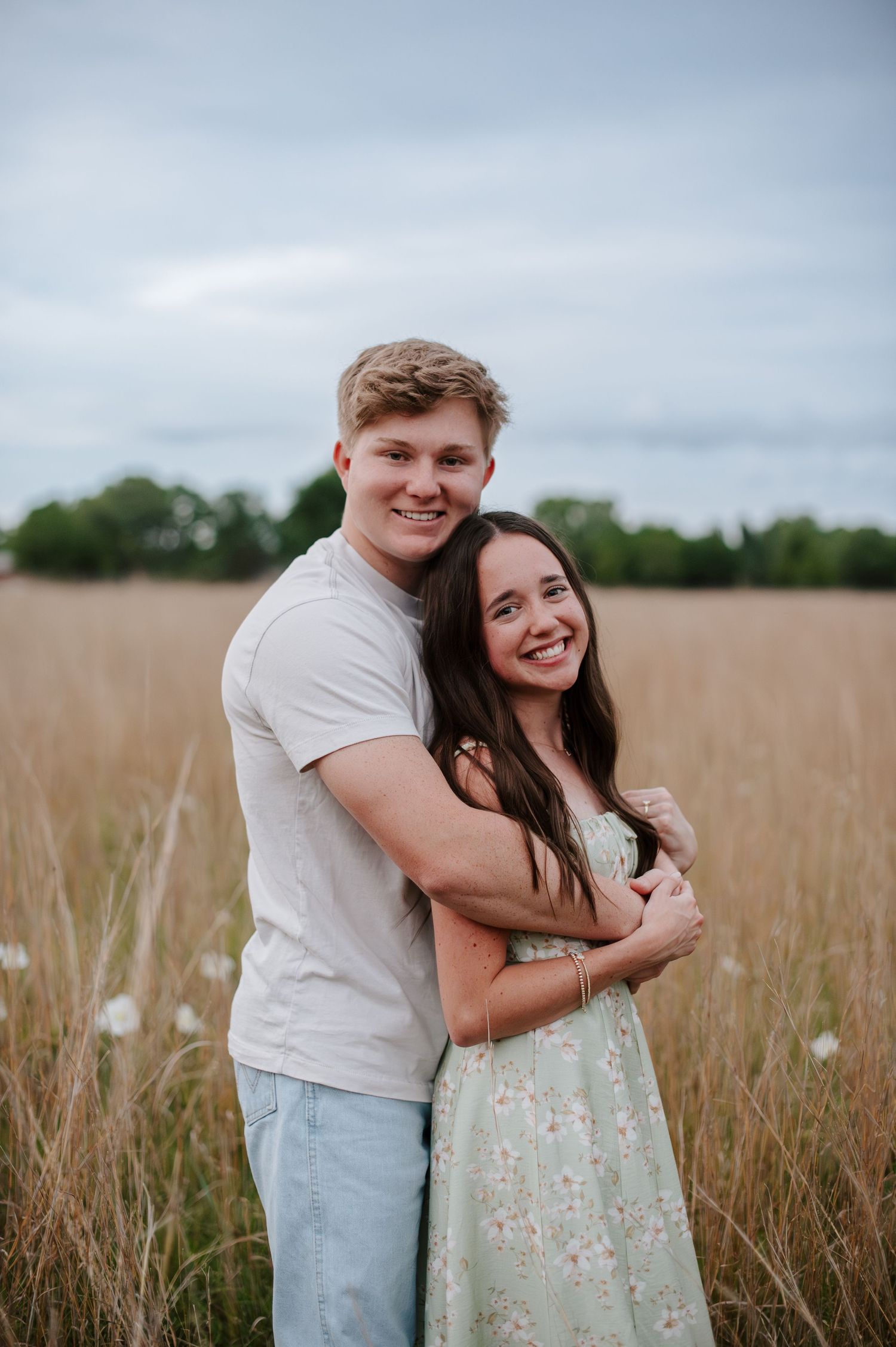 Wichita KS outdoor engagement photos in nature location Andover, couple photos in field with flowers, small elopement wedding photographer