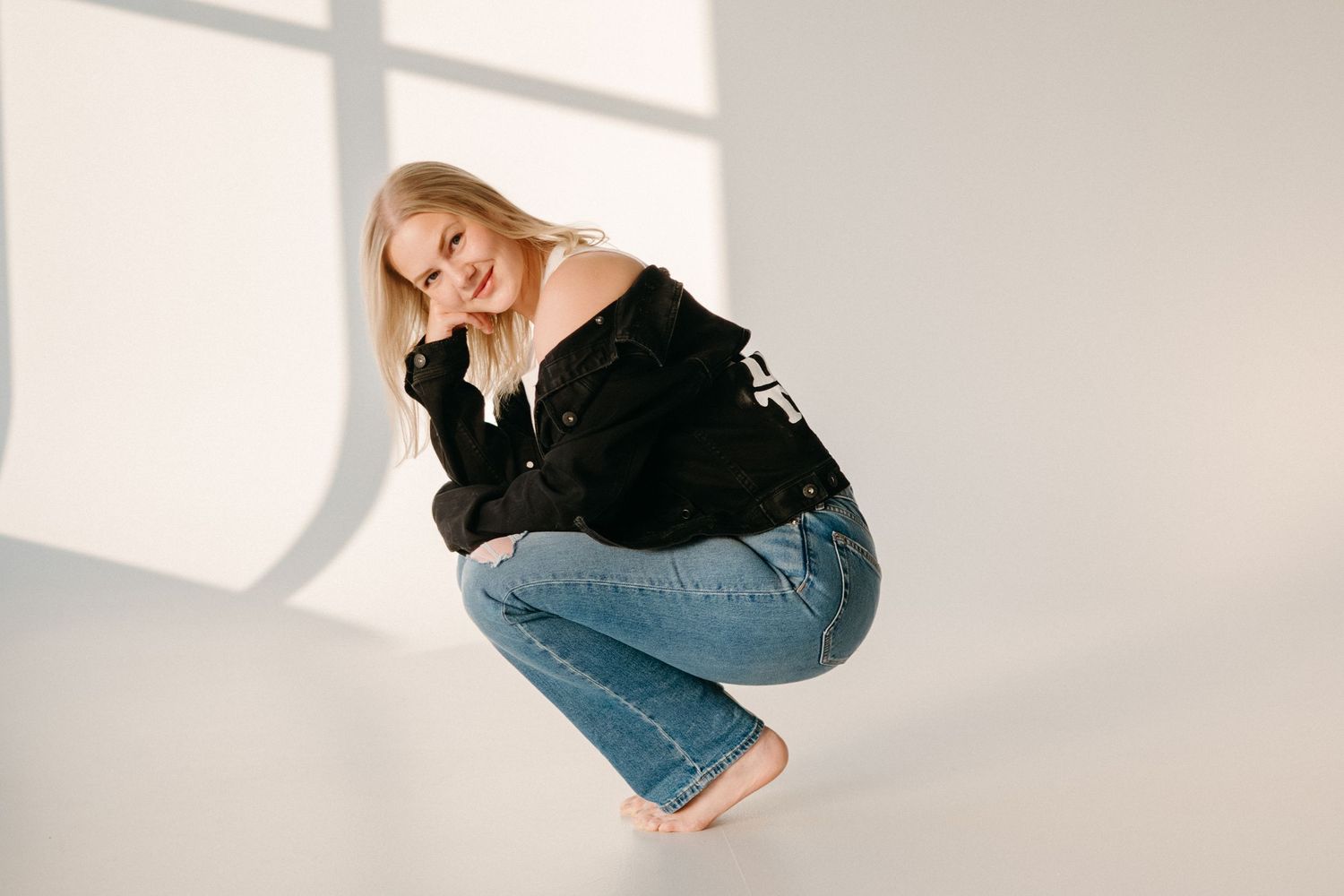 Woman posing confidently and showing her personality during a professional studio branding shoot.