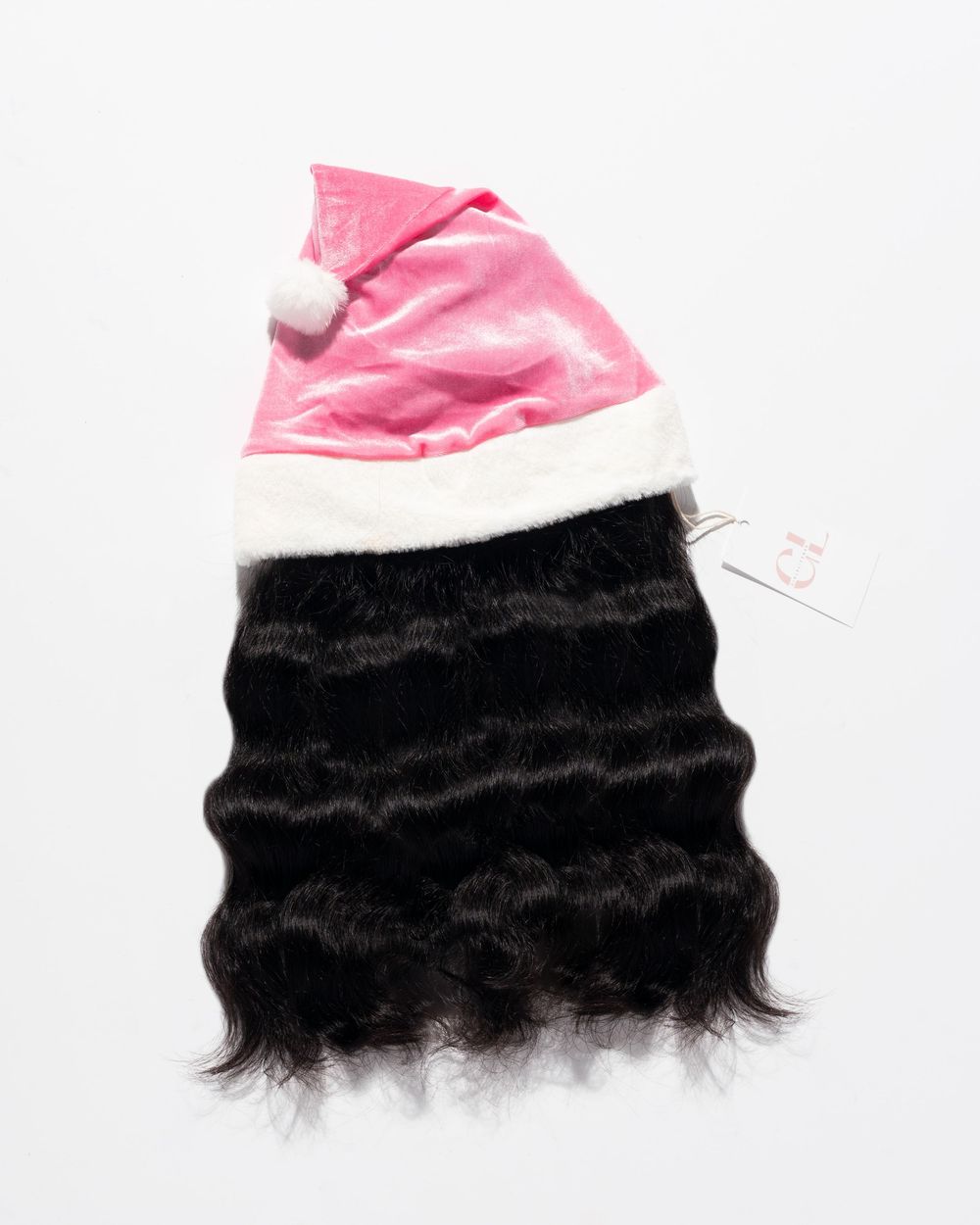 Black wavy hair extension displayed with a pink Santa hat, perfect for festive holiday styling.