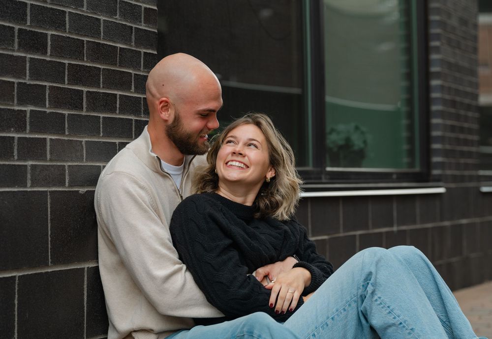 couple on ground holding each other