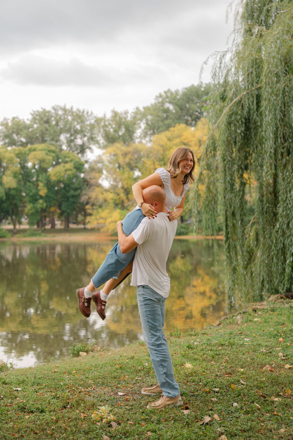 man picking up his fiance in the air and spinning her