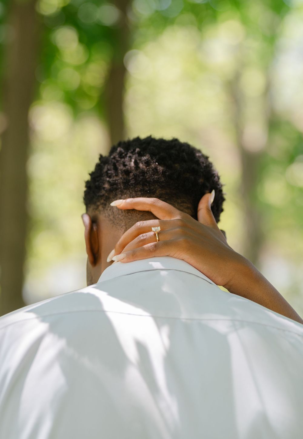 close up of girls hand on guys neck