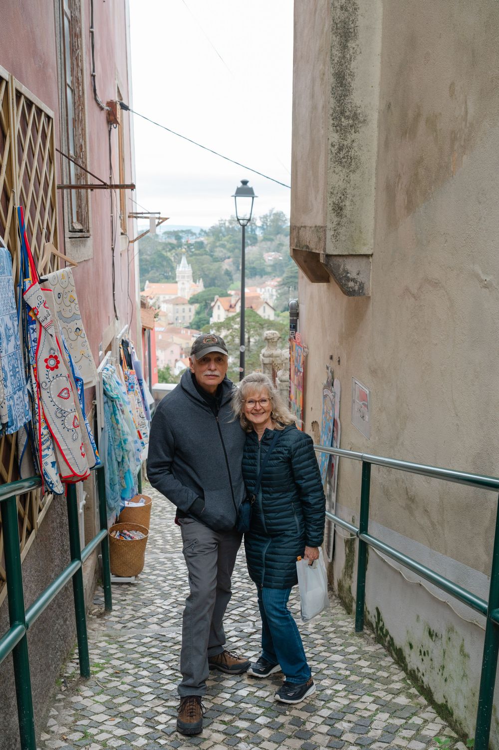 A couple in front of an outlook in Portugal