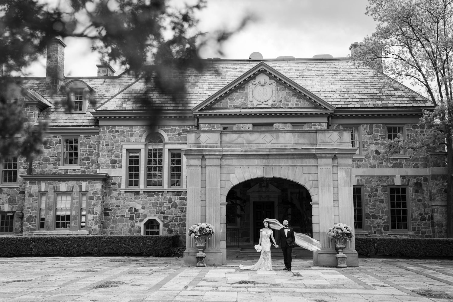 Historic stone buildings and archways photographed in black and white panoramic view.