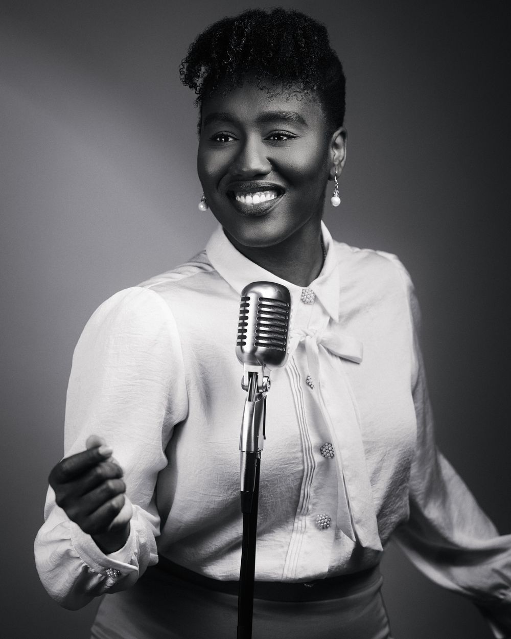 Retro energy and joy shine through crisp highlights and soft background gradient; vintage mic anchors the composition.