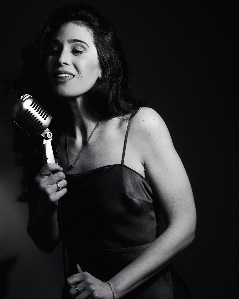 Satin-draped singer mid-note, haloed by sculpted shadows — a quintessential Postmodern Lightbox mood.