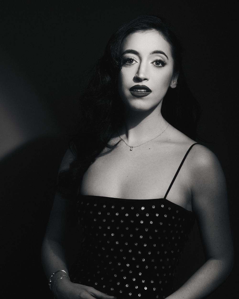Polka-dotted soprano in soft focus, leaning into the mic, bringing the past into the present with signature Postmodern Lightbox styling.