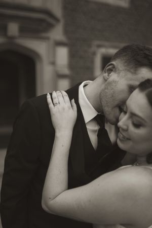 An intimate black and white wedding portrait captured in dramatic lighting.