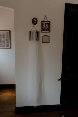Empty room with white walls, wooden floors and hanging veil decoration.
