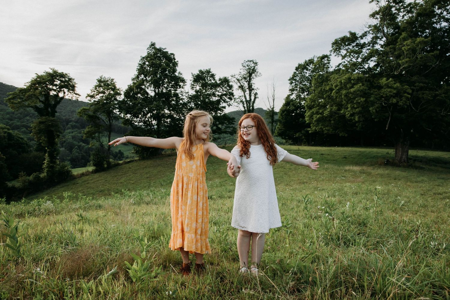 Photo of sisters holding hands in a field