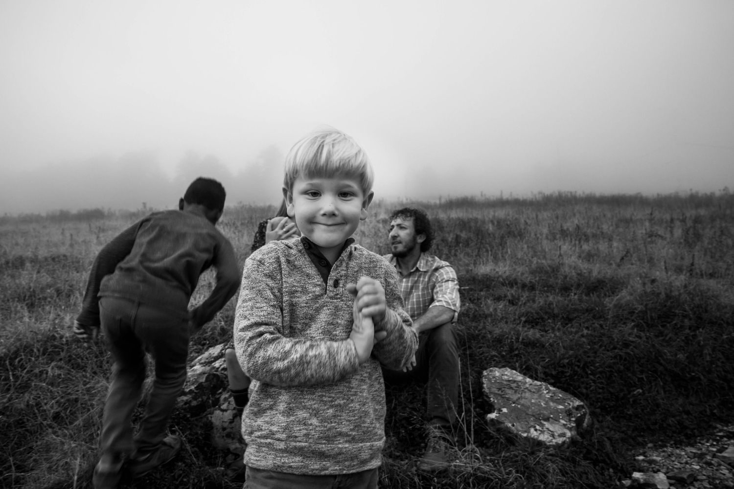 Black and white photo of a family on a mountaintop at sunset for a family photo shoot on Whitetop Mountain in southwest Virginia