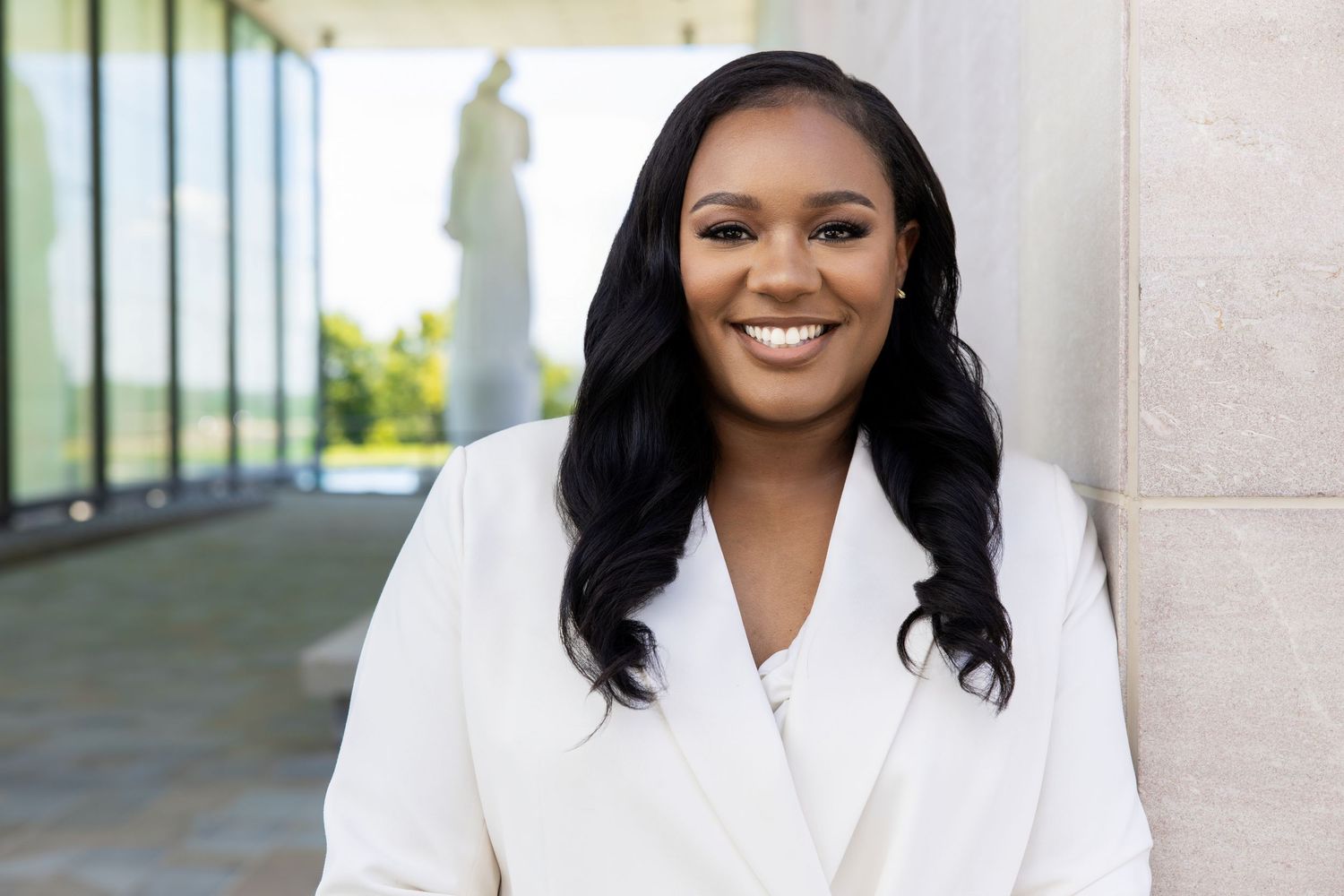 Professional headshots series showing person in white blazer against neutral background.