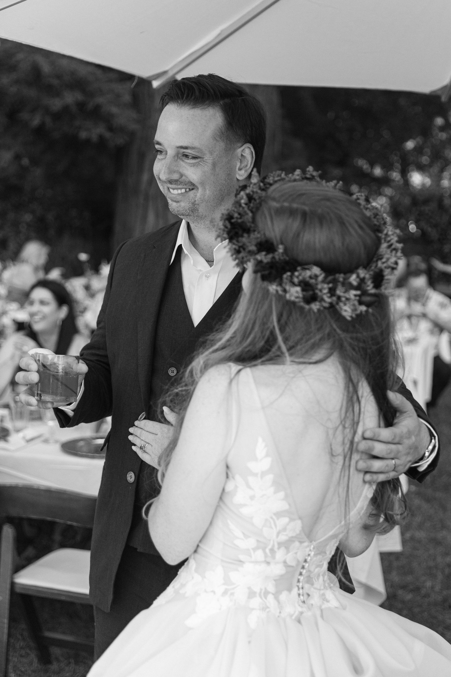 Happy couple shares joyful moments during their outdoor wedding celebration.