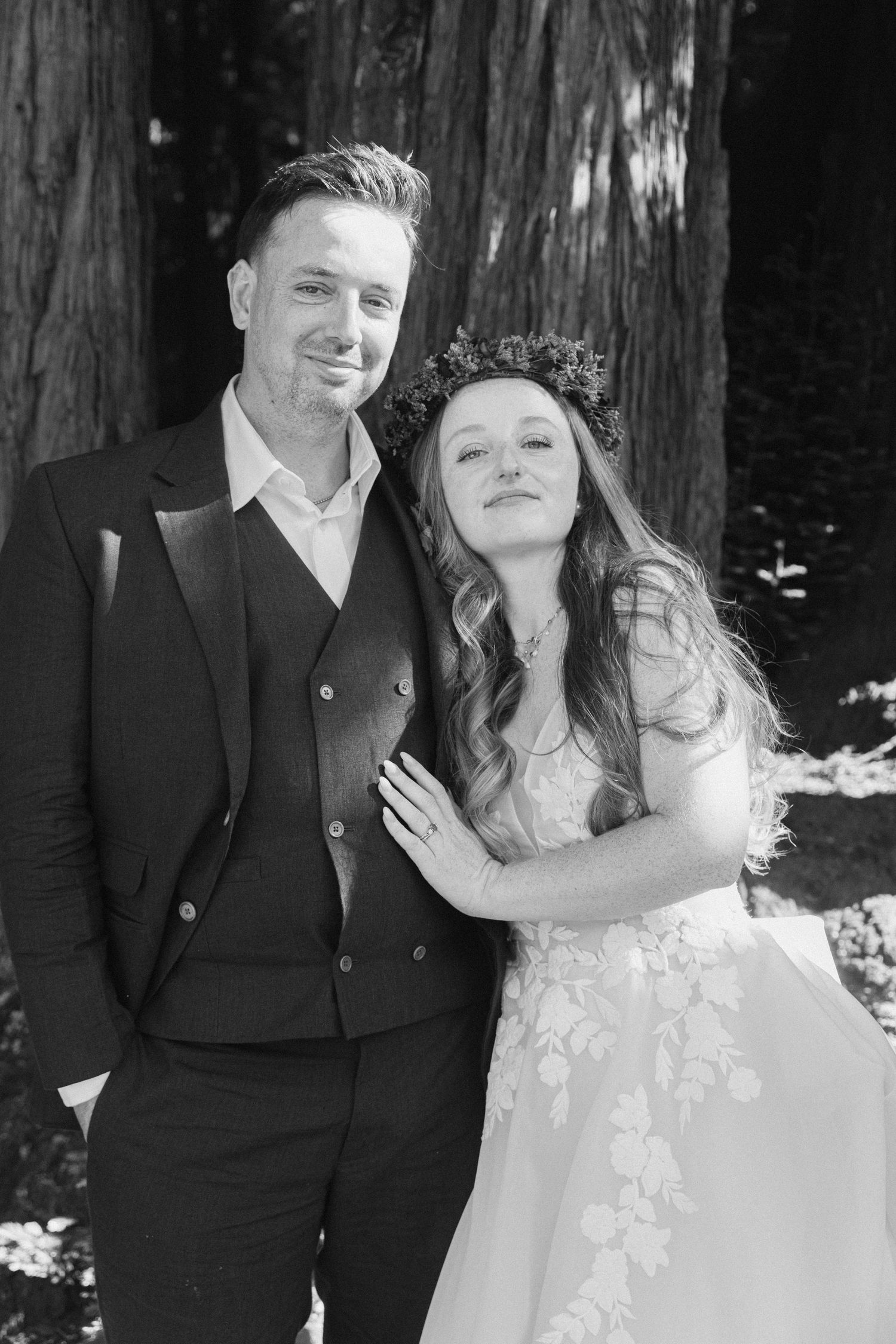 Wedding couple poses for romantic portraits among majestic redwood trees.
