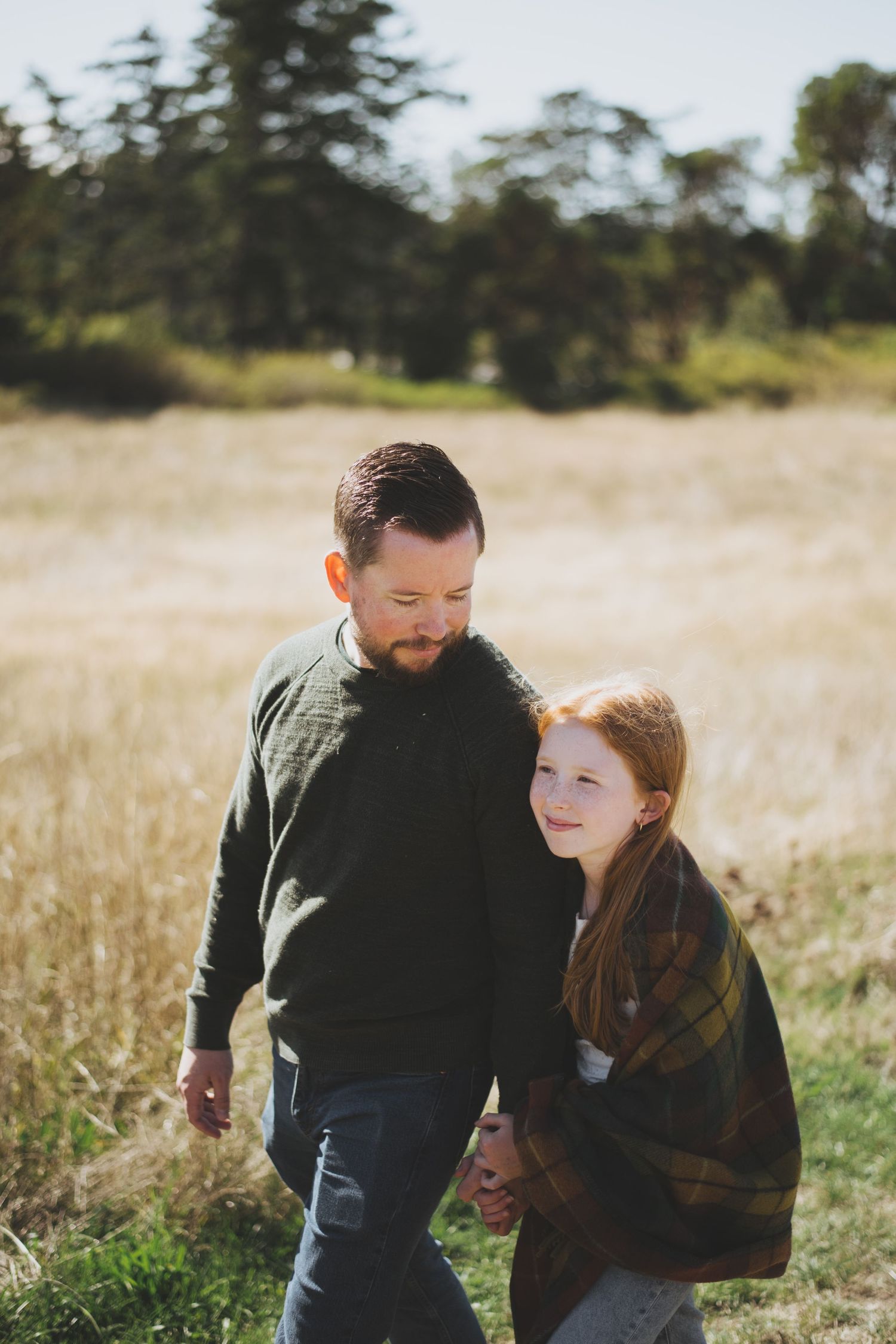 A walk together through a golden meadow on a sunny afternoon.