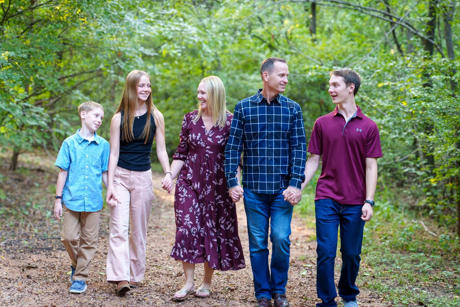 Fall family mini session Keller Texas walking holding hands fall warm colors teenage kids smiles Christmas cards photos