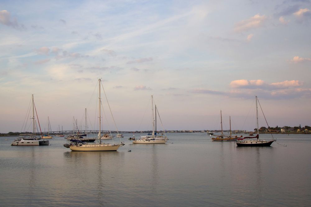Sailboats moored in the inlet at St Augustine with cotton candy skies above