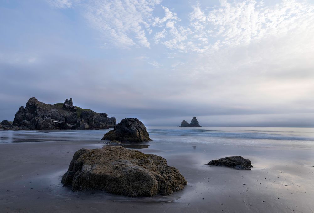 Dusk in the Pacific Northwest as rock outcroppings lead the eye out to the ocean