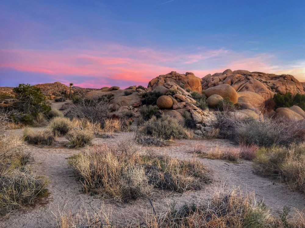 Pink Skies at sunset at Joshua Tree National Park with rocks shaped in perfect spheres