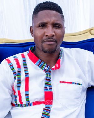 Modern African fashion design features white shirt with colorful striped detailing and geometric patterns.