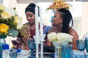 Elegant table setting with colorful floral centerpieces at formal celebration.