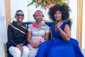 Group photo featuring traditional and modern African fashion at formal event.
