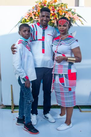 Family portrait with coordinated red, white and blue African-inspired outfits.