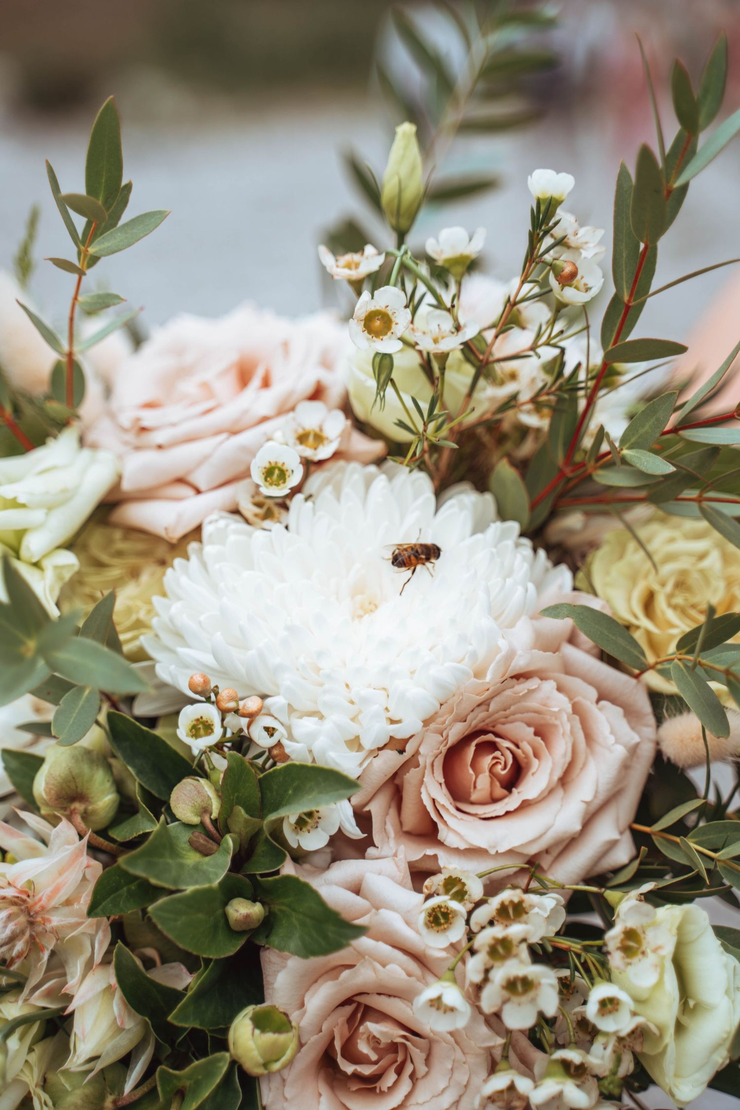 A tiny bee lands on a lush wedding bouquet, adding a touch of nature. Calgary wedding.