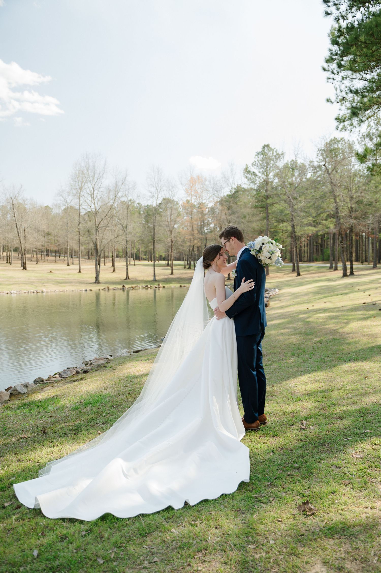 Groom kisses bride as they embrace