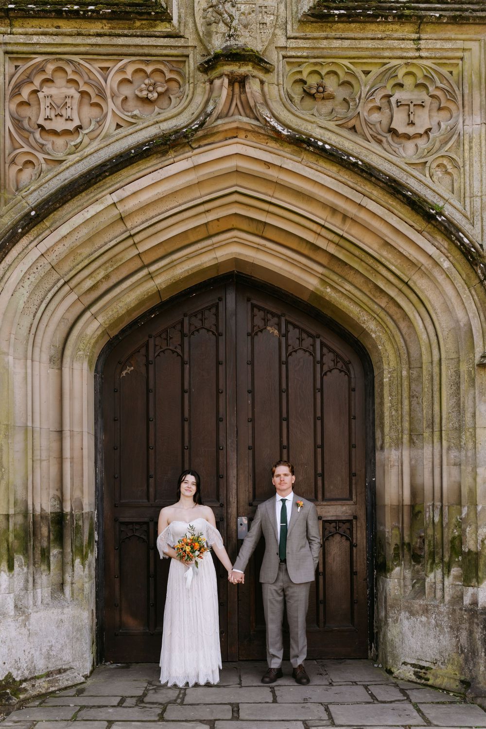 Gothic stone archways with ornate carvings frame a series of wedding photos at a historic cathedral entrance.