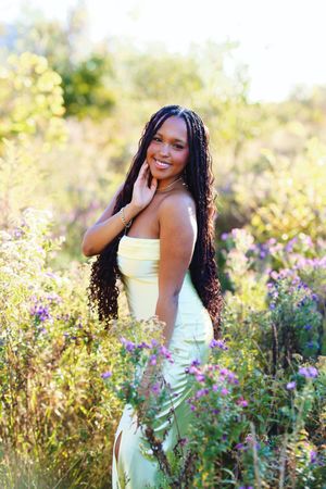 A joyful portrait session in a wildflower meadow at golden hour featuring a white dress and natural lighting.