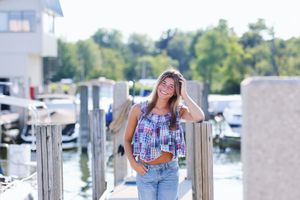 A group of lifestyle photos showing people relaxing and socializing at a waterfront dock on a sunny day.