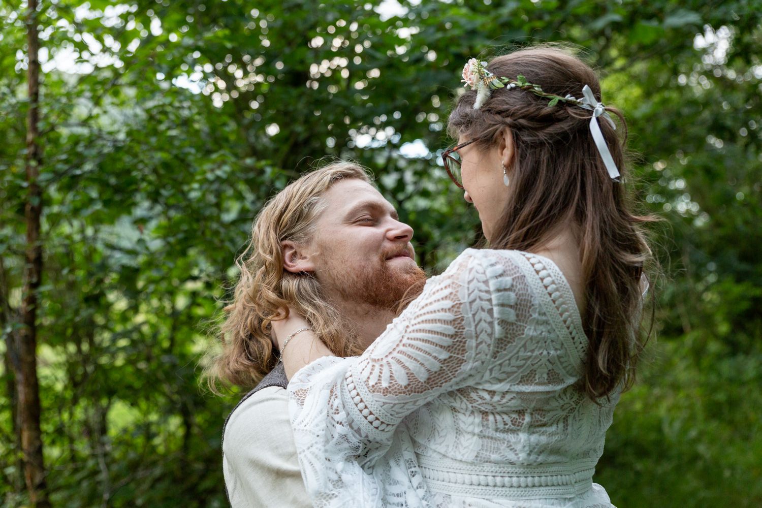 Close up portrait of a bride and groom gazing into each others eyes in a woodland glade. North Wales Wedding Photographer