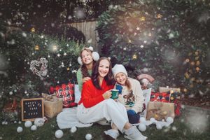 Winter holiday photo scene with wrapped presents and magical light effects in an outdoor setting.