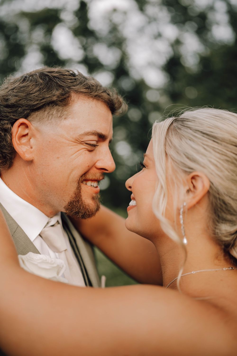 A romantic wedding photo sequence showing a couple sharing intimate laughs and loving glances outdoors.