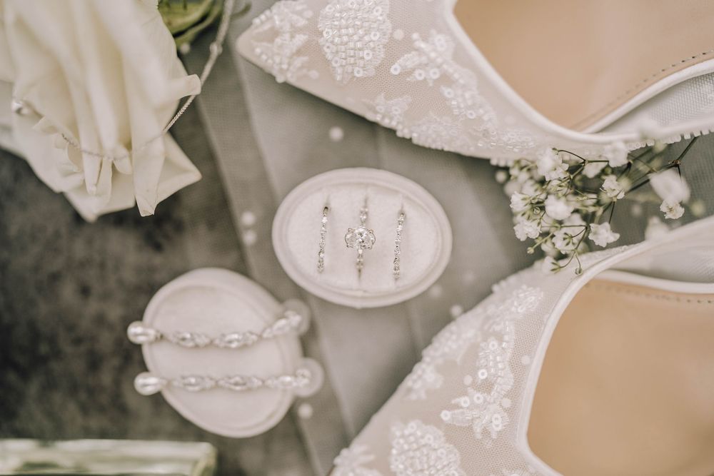 Elegant white lace wedding dress details with delicate embroidered patterns and textures.