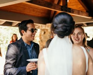 Guests mingling and socializing at an outdoor wedding reception.