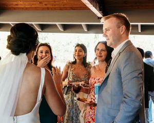 Wedding guests mingling and socializing during an indoor reception celebration.