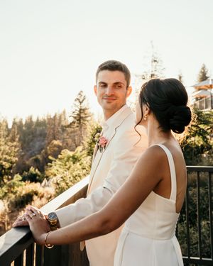 A romantic couple shares intimate dance moves during a sunset wedding reception on an outdoor terrace.