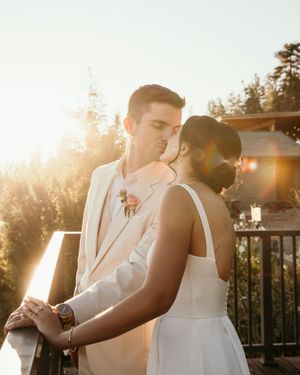 A couple shares an intimate dance moment at sunset on an outdoor patio.