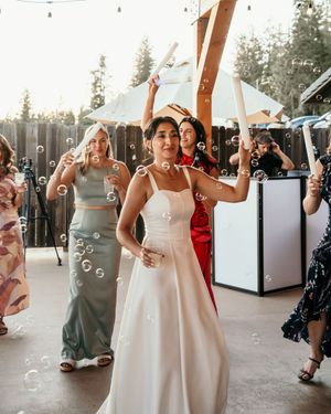 Wedding reception scene with bubbles floating through the air as guests celebrate.