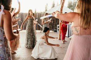 Wedding guests dancing and enjoying themselves on a covered outdoor dance floor.