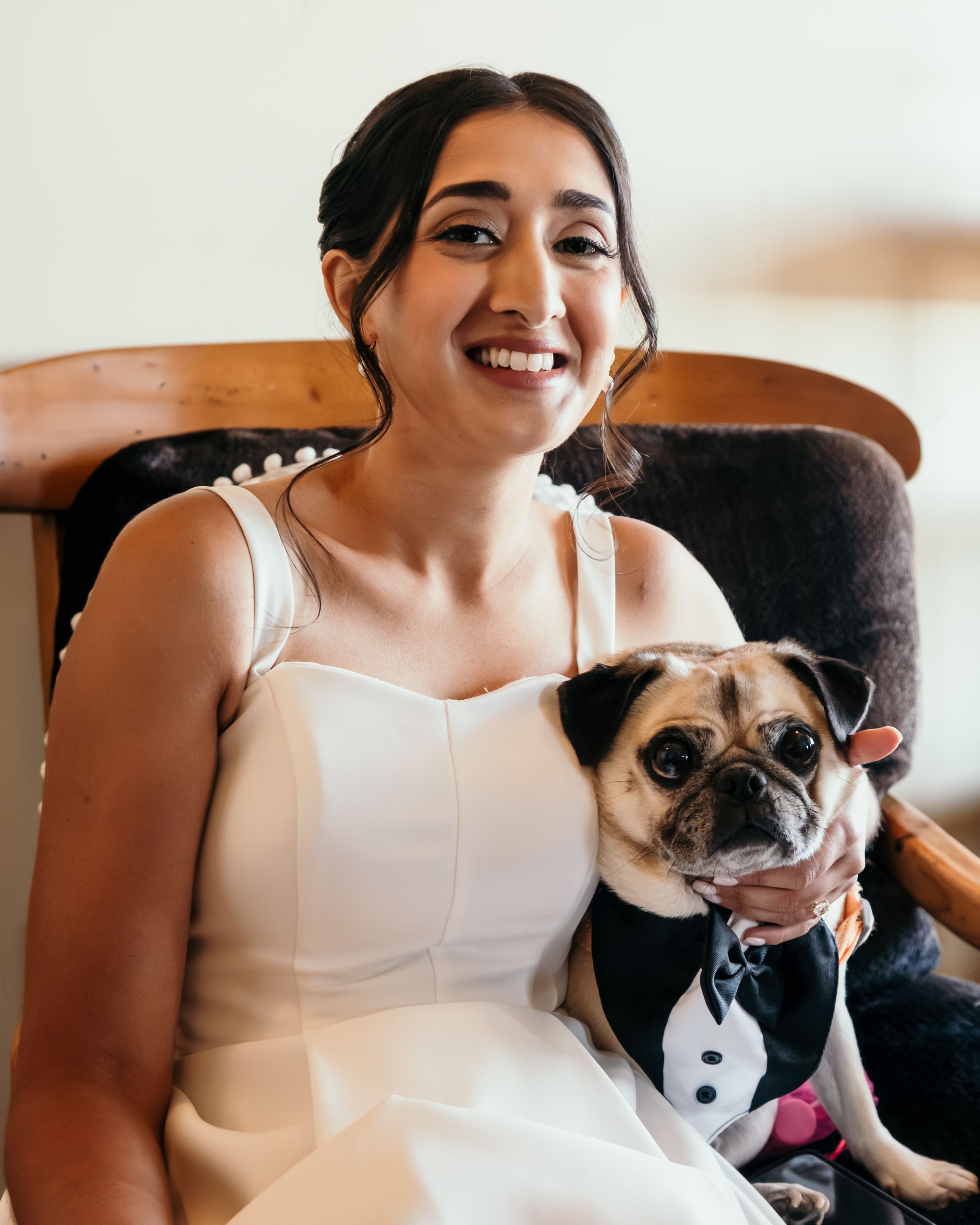 A sweet moment with a small dog in formal attire at a wedding.