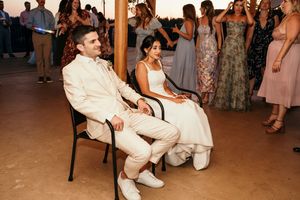 Guests enjoying a lively dance party at a rustic wedding venue.