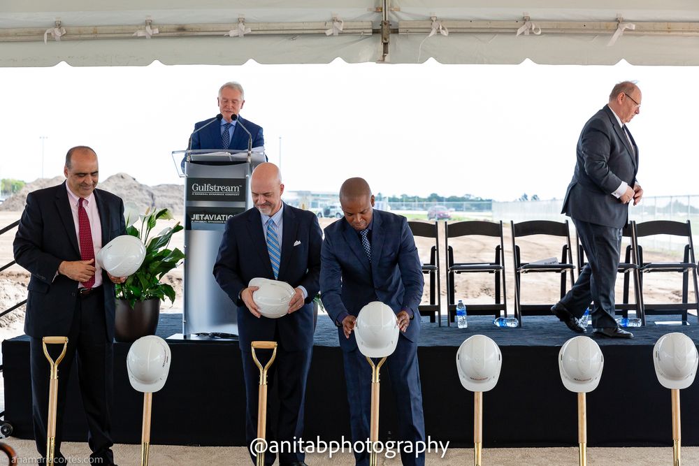 Business leaders prepare for groundbreaking ceremony with ceremonial gold shovels and white balloons.
Ground braking event.