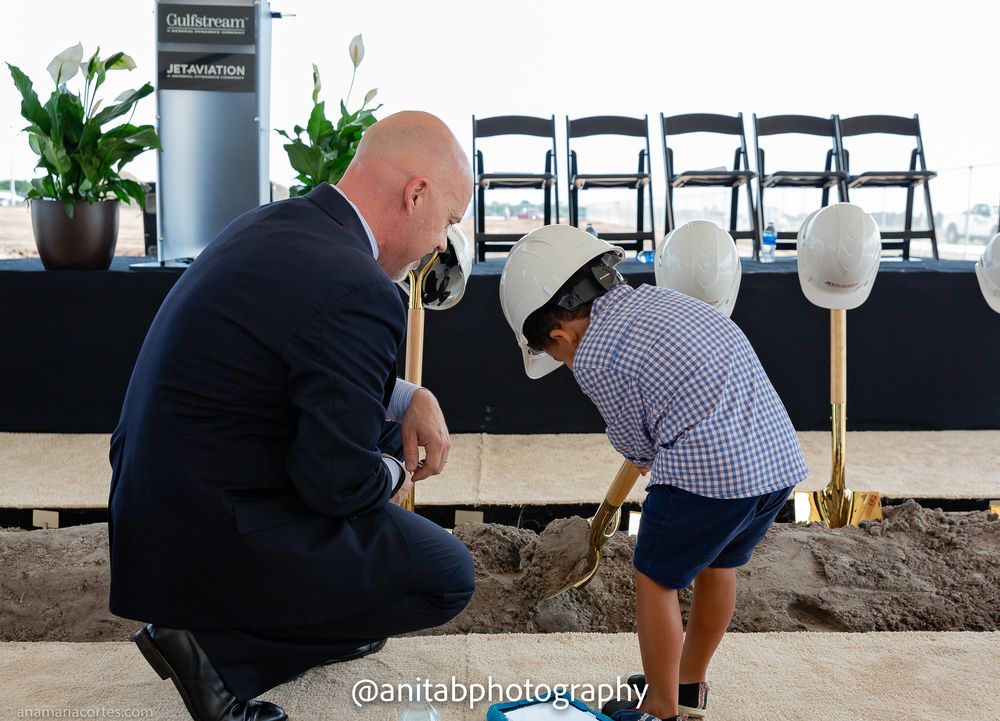 Construction workers and officials participate in a ceremonial groundbreaking event with golden shovels.
Ground braking event.