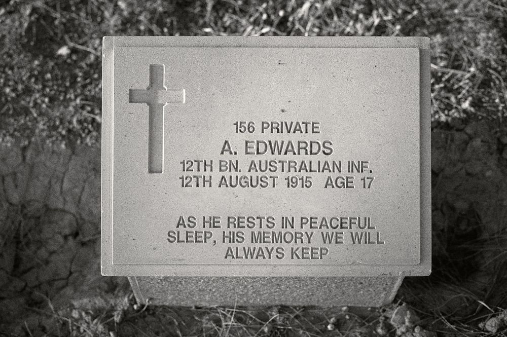 A military gravestone with a cross shows inscription for Private S. Edwards of the 12th Australian Infantry who died at age 17.