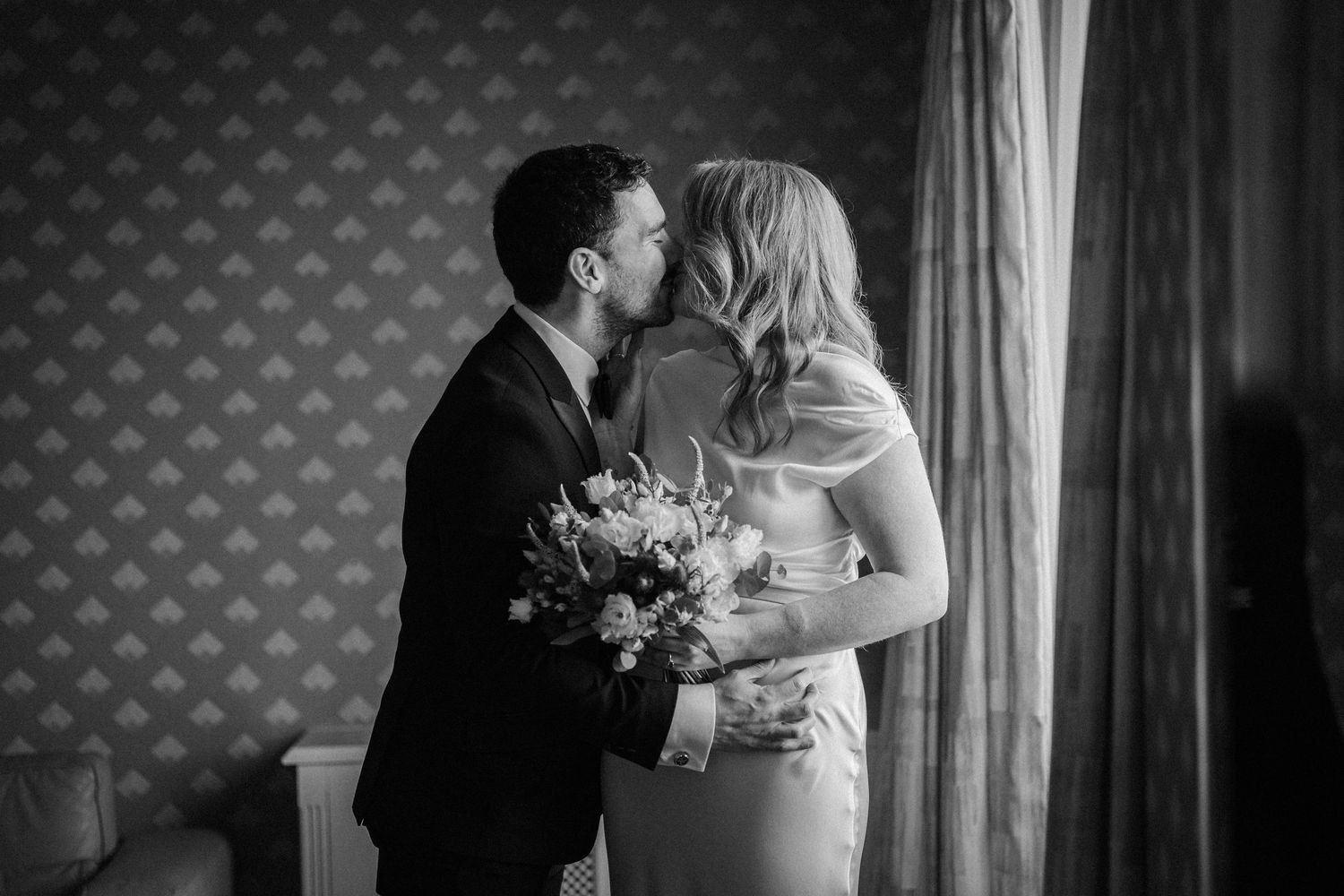 Romantic black and white wedding moment with soft lighting and elegant decor.